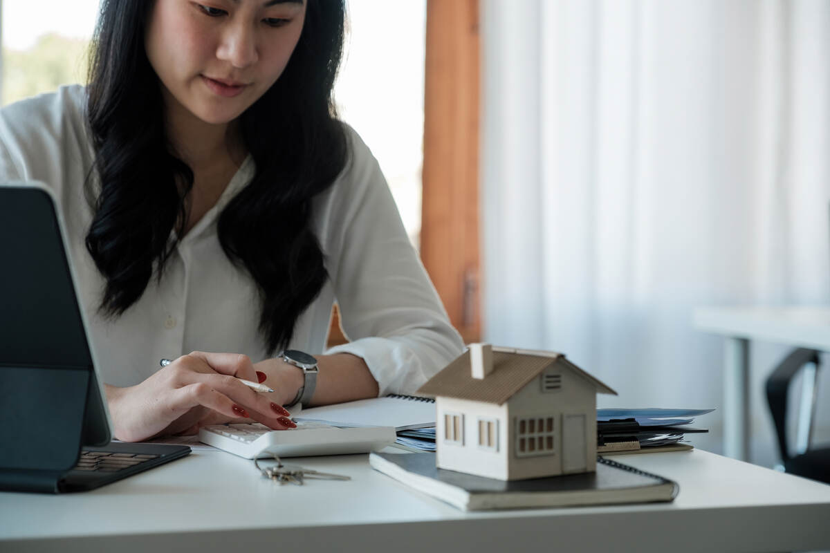 the girl calculates the mortgage on the calculator