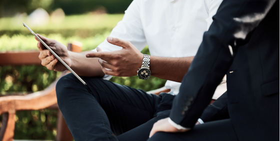 men sitting and looking at the tablet screen