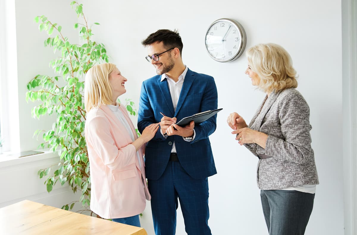  a man and a woman sign a contract with a home agent for a second mortgage