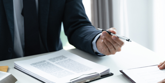 man reading and holding a pen