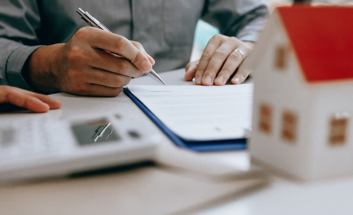 Man signing escrow agreement in real estate