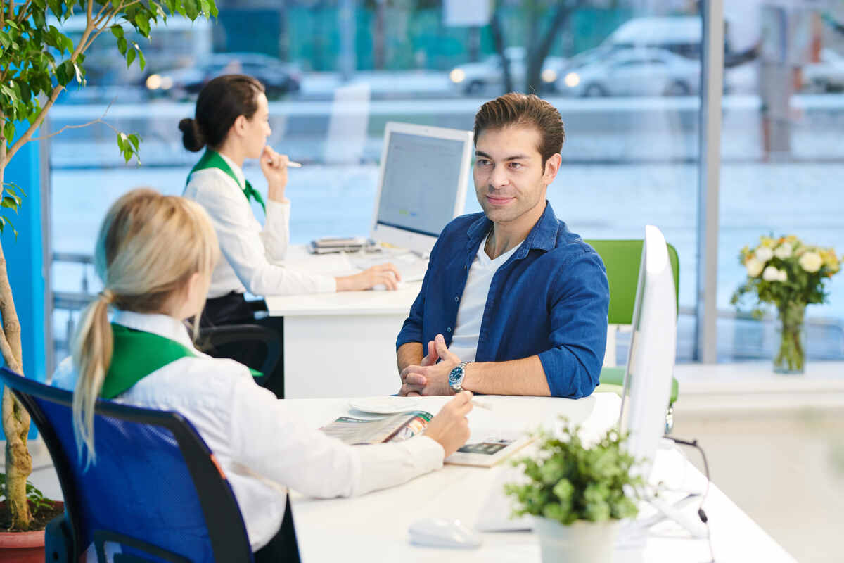 young man listening to bank manager